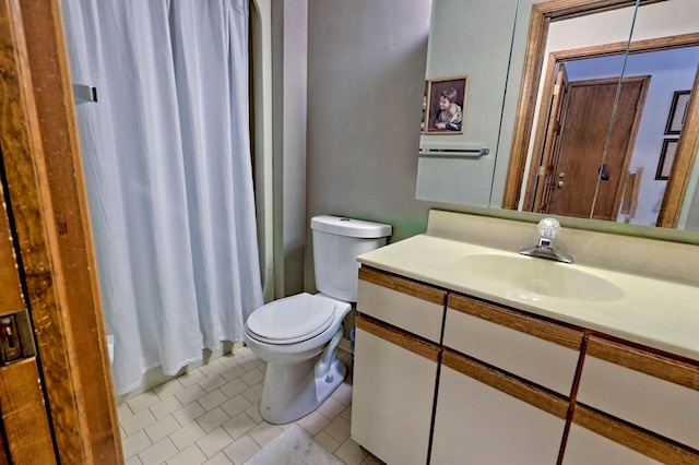 bathroom featuring vanity, tile patterned flooring, a shower with curtain, and toilet