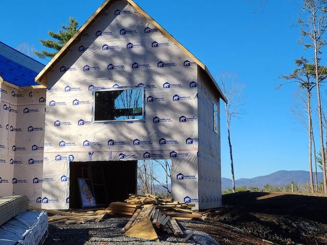 view of side of home featuring a mountain view