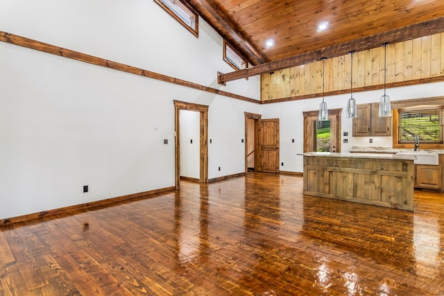 unfurnished living room with beam ceiling, sink, high vaulted ceiling, wood ceiling, and hardwood / wood-style flooring