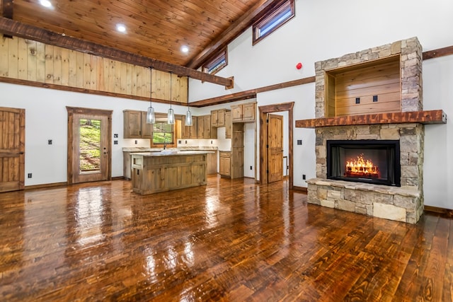 unfurnished living room featuring dark wood-type flooring, a fireplace, high vaulted ceiling, and wooden ceiling