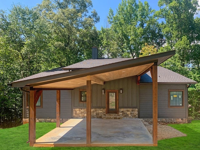 back of house featuring a patio area and a yard