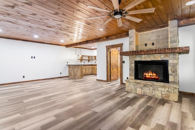 unfurnished living room with ceiling fan, a fireplace, wood ceiling, and light hardwood / wood-style floors