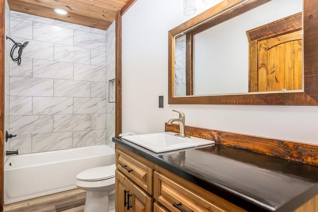 full bathroom featuring vanity, wood-type flooring, tiled shower / bath combo, toilet, and wood ceiling