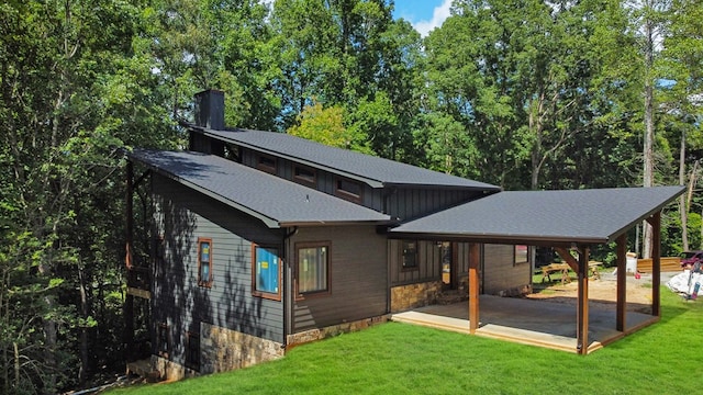 rear view of house featuring a patio and a lawn