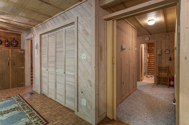 hallway featuring wooden walls