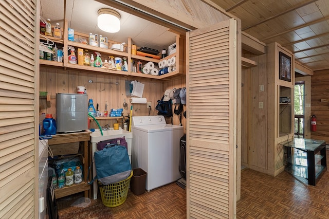 washroom with wooden walls, laundry area, and washer / dryer