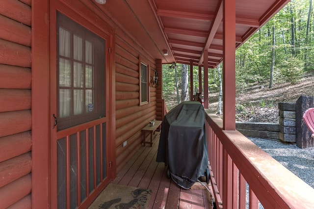 wooden terrace with a grill