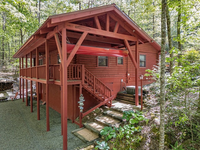 exterior space featuring cooling unit and stairs