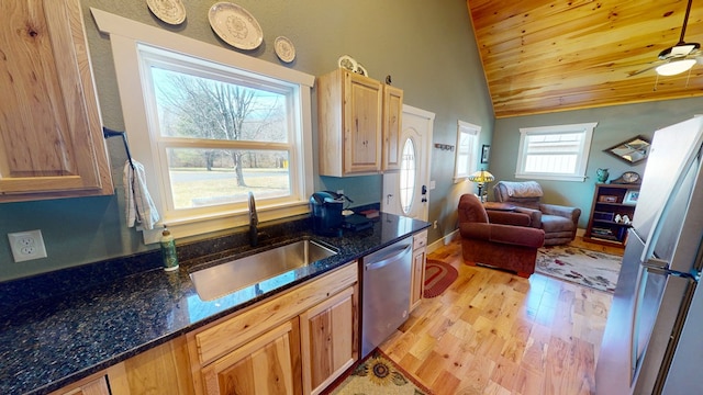 kitchen with lofted ceiling, wooden ceiling, light wood finished floors, a sink, and appliances with stainless steel finishes