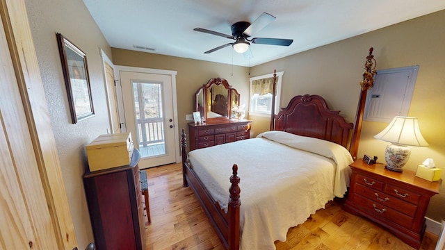 bedroom featuring light wood-type flooring, visible vents, a ceiling fan, and access to exterior
