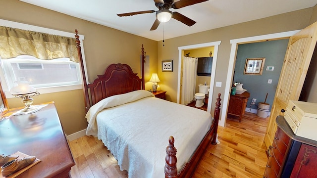 bedroom featuring ceiling fan, connected bathroom, baseboards, and light wood-type flooring