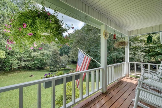 deck featuring a porch and a lawn