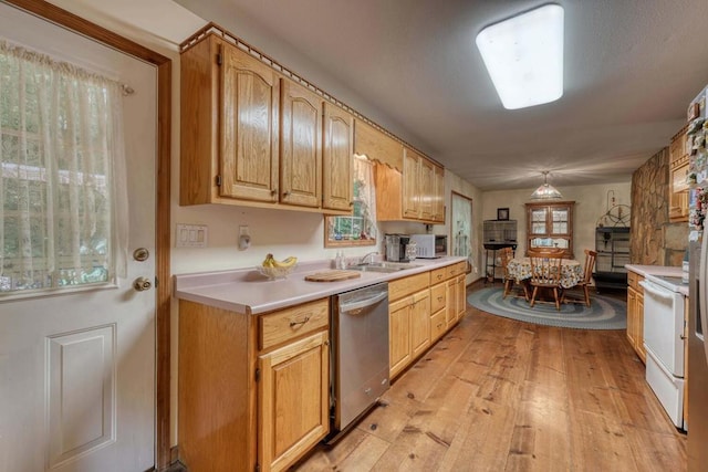 kitchen featuring light hardwood / wood-style flooring, pendant lighting, sink, and white appliances