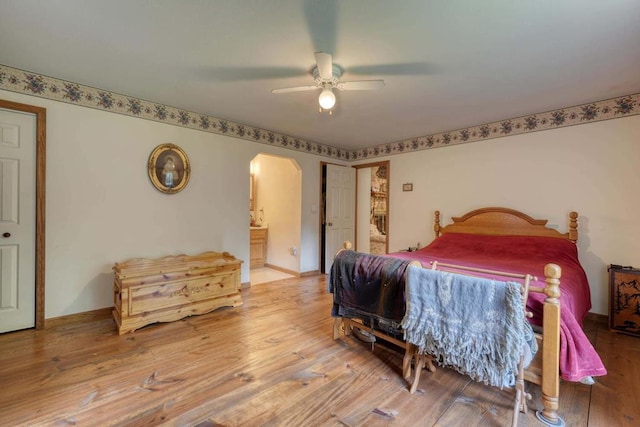 bedroom with hardwood / wood-style flooring, ensuite bathroom, and ceiling fan