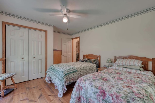 bedroom featuring light wood-type flooring, a closet, and ceiling fan