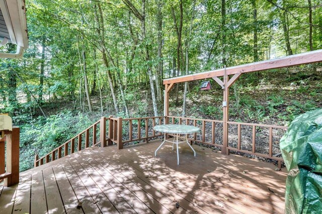 view of side of property featuring a garage and a deck