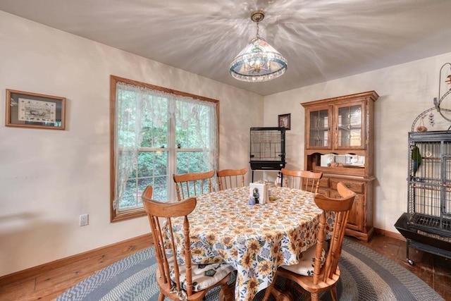 dining room with a chandelier and dark hardwood / wood-style flooring