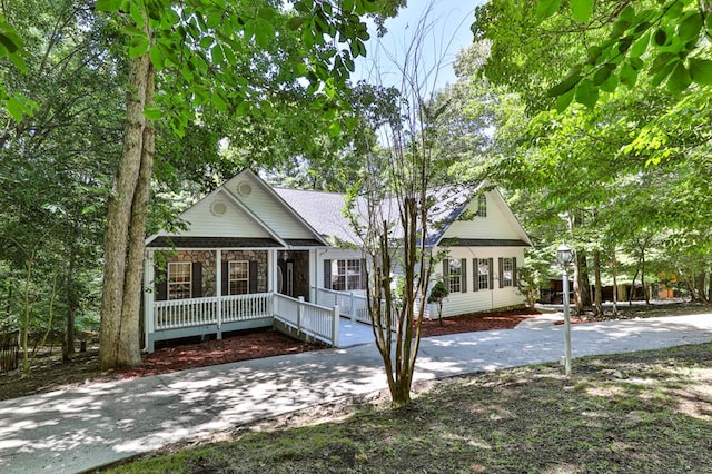 single story home with stone siding and covered porch