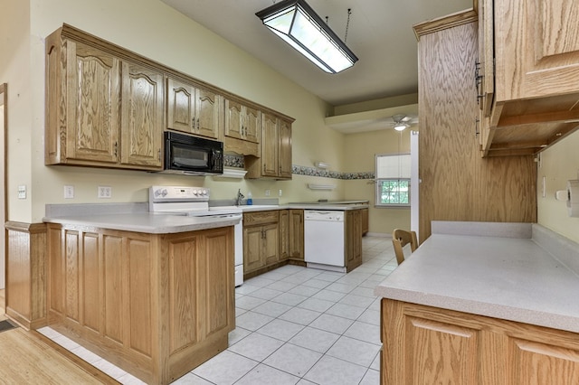 kitchen with white appliances, a peninsula, light countertops, light tile patterned floors, and ceiling fan