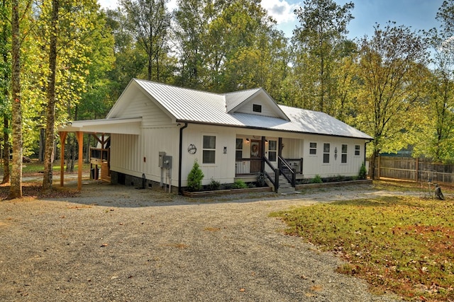 view of front of property with covered porch and a carport