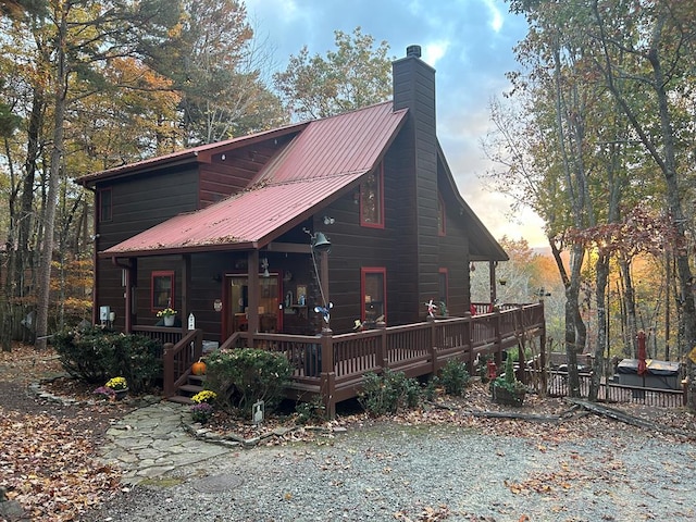 back house at dusk with a wooden deck