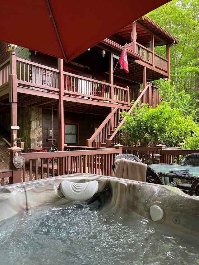 exterior space featuring a hot tub and a deck