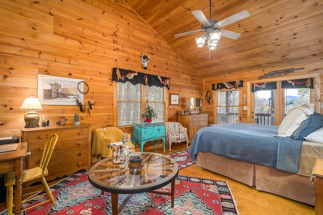 bedroom with ceiling fan, light hardwood / wood-style flooring, high vaulted ceiling, wood walls, and wood ceiling