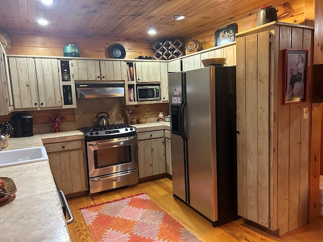 kitchen with wooden ceiling, sink, light hardwood / wood-style flooring, range hood, and stainless steel appliances