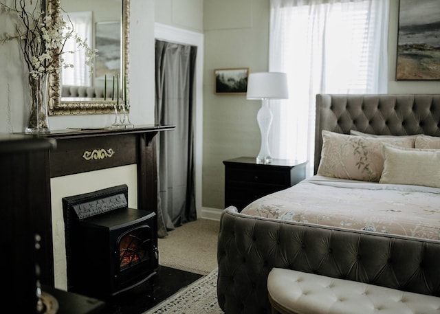 477 W First St, Blue Ridge, GA 30513 - carpeted bedroom featuring a wood stove and baseboards