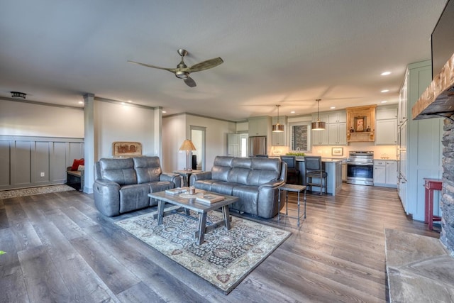 living room with dark hardwood / wood-style floors, a textured ceiling, and ceiling fan