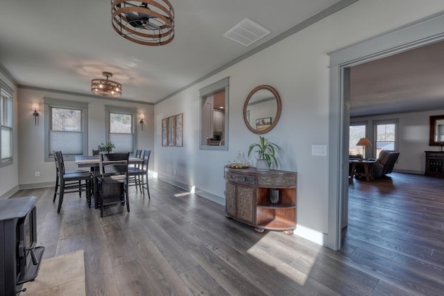 dining room with crown molding and dark hardwood / wood-style floors