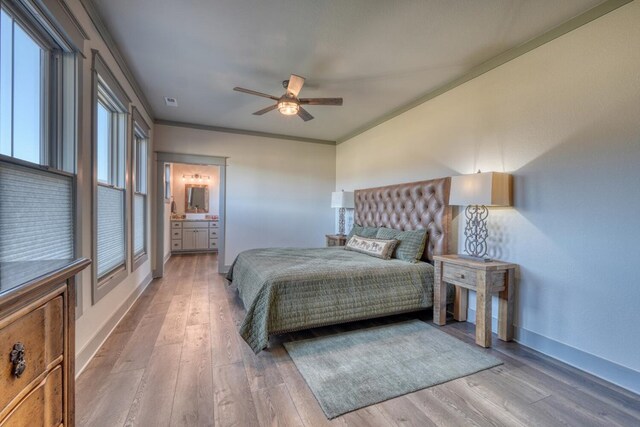 bedroom featuring ceiling fan, ornamental molding, ensuite bathroom, and light hardwood / wood-style floors