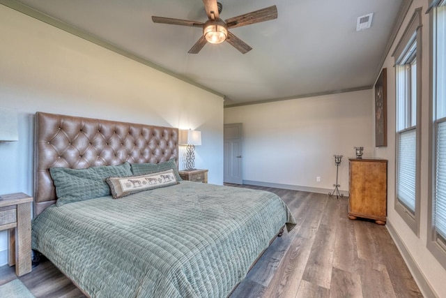 bedroom featuring crown molding, hardwood / wood-style floors, and ceiling fan