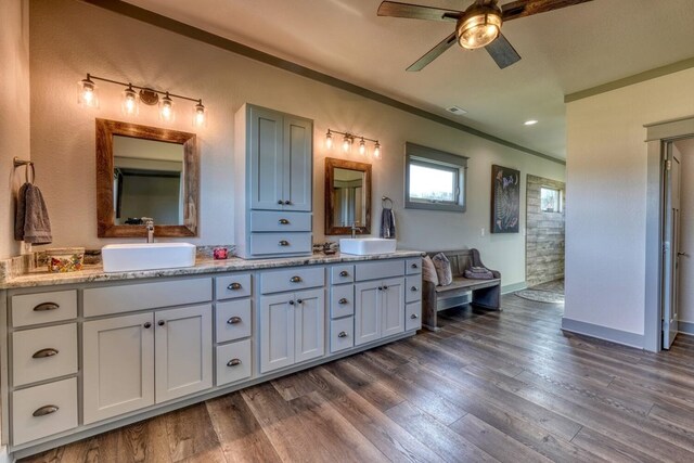 bathroom with vanity, hardwood / wood-style floors, ornamental molding, and ceiling fan