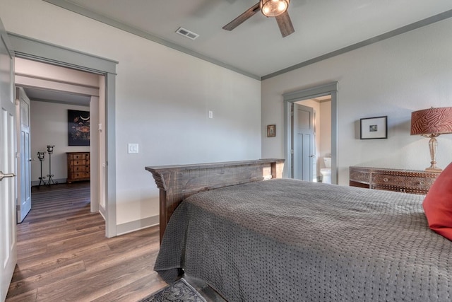 bedroom featuring ceiling fan, ornamental molding, and wood-type flooring