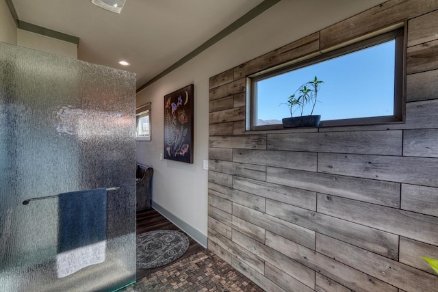 bathroom featuring wood walls