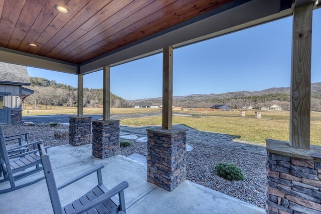 view of patio / terrace featuring a mountain view and a rural view