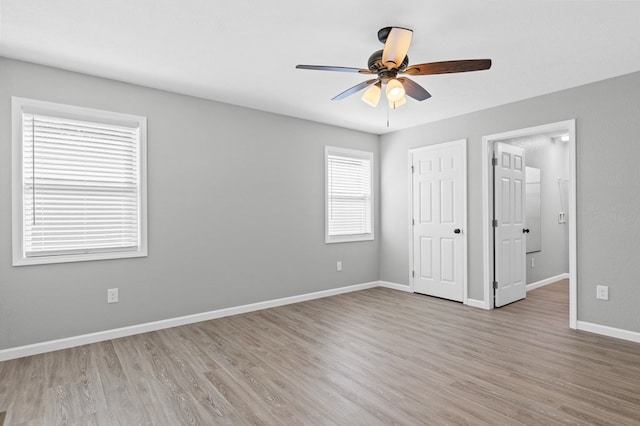 unfurnished bedroom featuring a ceiling fan, baseboards, and light wood-type flooring