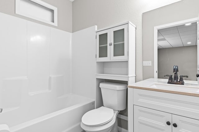 full bathroom with vanity, washtub / shower combination, and toilet