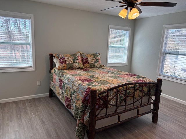 bedroom featuring baseboards, a ceiling fan, and wood finished floors