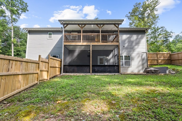 back of property with a fenced backyard and a yard