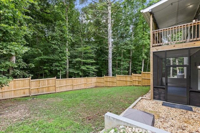 view of yard with a fenced backyard and a sunroom