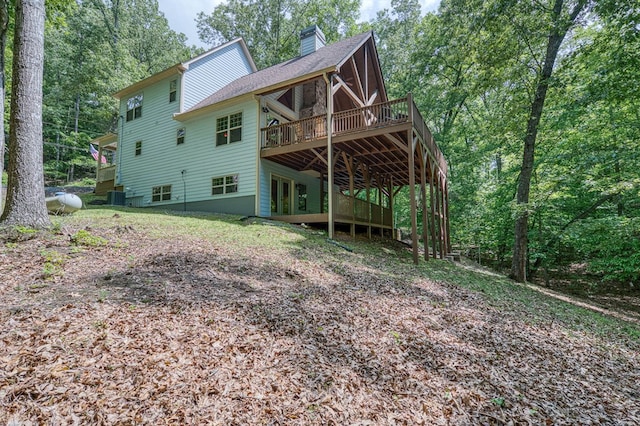 249 Whispering Pine Trl, Murphy, NC 28906 - back of house with a chimney, a deck, cooling unit, and a shingled roof