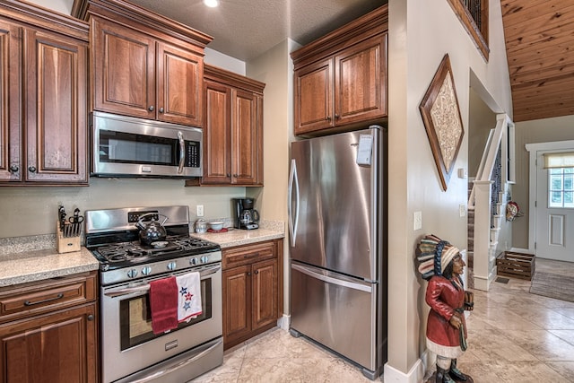 249 Whispering Pine Trl, Murphy, NC 28906 - kitchen featuring stainless steel appliances, baseboards, and light stone counters