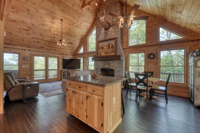 kitchen featuring ceiling fan, open floor plan, and wooden ceiling