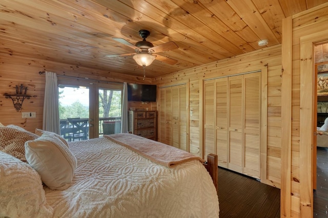 bedroom featuring two closets, hardwood / wood-style floors, access to exterior, wooden walls, and wood ceiling