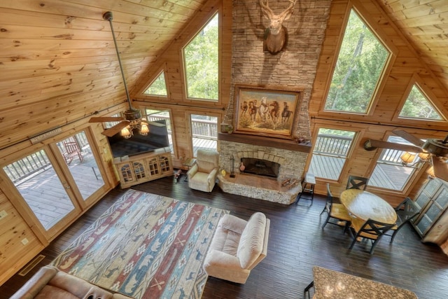 living area featuring a wealth of natural light, high vaulted ceiling, and wooden ceiling