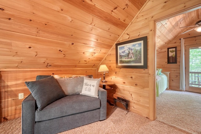 living area featuring carpet floors, wooden walls, vaulted ceiling, and wood ceiling