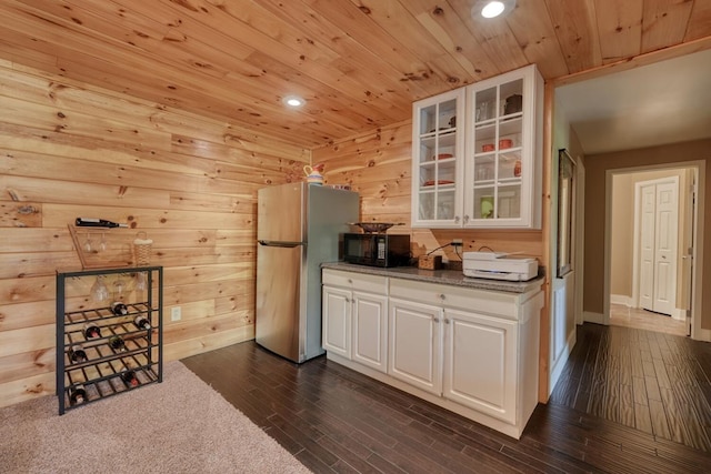 kitchen featuring freestanding refrigerator, dark wood-style flooring, black microwave, recessed lighting, and wood ceiling