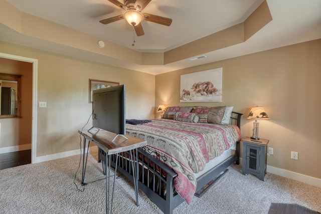 bedroom with visible vents, a ceiling fan, refrigerator, baseboards, and carpet flooring